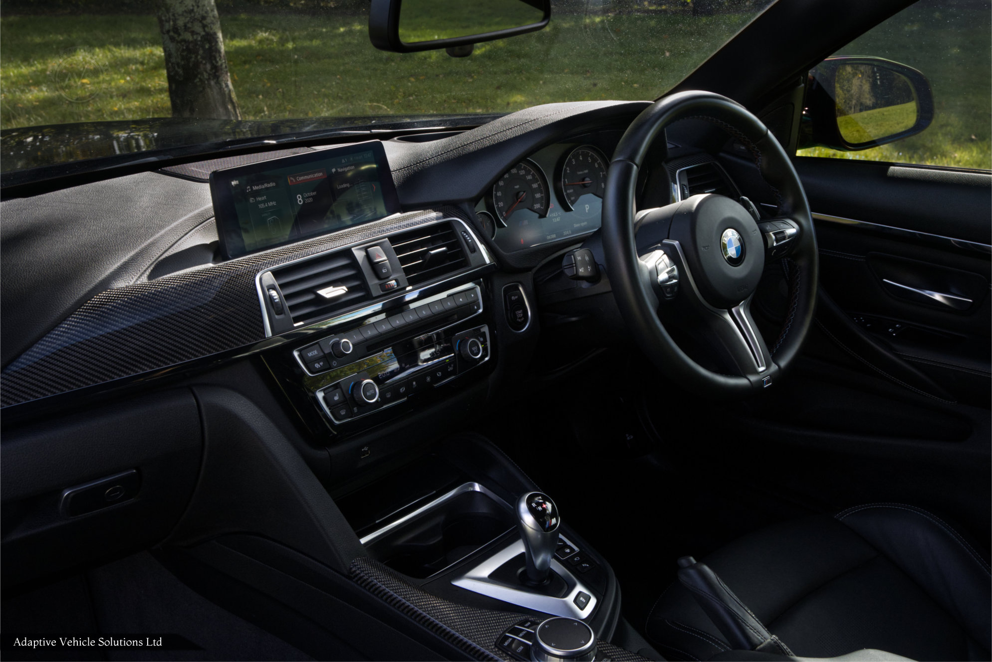 BMW M4 Competition black coupe passenger side interior view