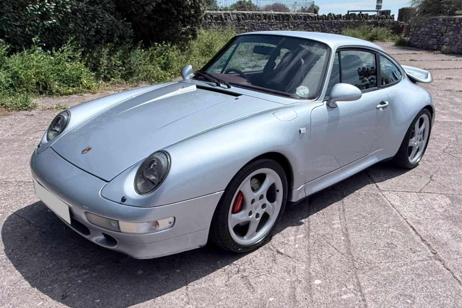 Near side front view of Porsche 911 993 Carrera 4S manual in artic silver