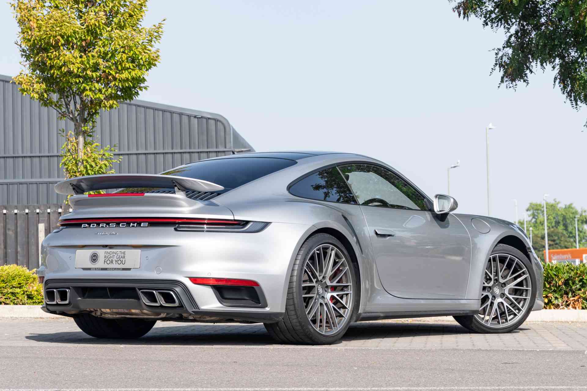 Porsche 911 992 Turbo Sourced Off side rear view of a Porsche 911 992 Turbo finished in Carrera Silver
